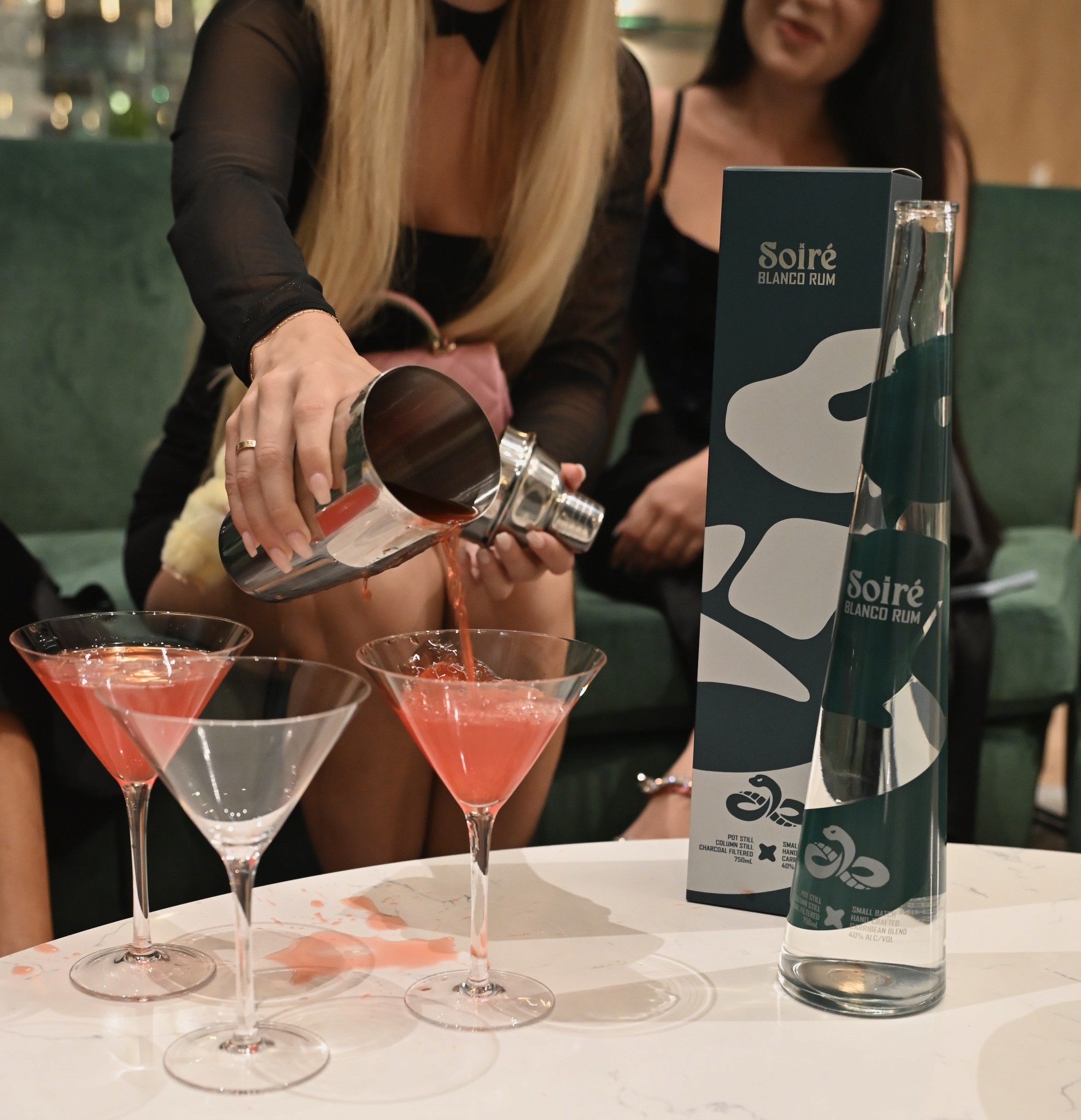 SOIRÉ Blanco bottle and presentation box beside freshly poured cocktails at a table